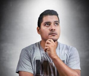 Man thinking with a concerned expression, representing users considering how to use Sanchar Saathi for mobile safety.