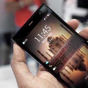 Jolla Phone running Sailfish OS shown in hand with lock screen display, highlighting an alternative smartphone focused on privacy.