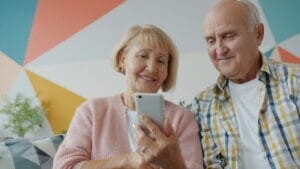 Senior couple using a smartphone, representing the user-friendly experience and clean Android interface on Micromax phones