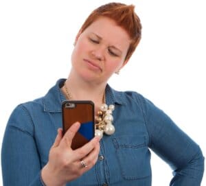 User looking at smartphone with concern due to phone battery draining fast