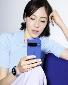 Woman using blue Google Pixel smartphone while sitting on sofa